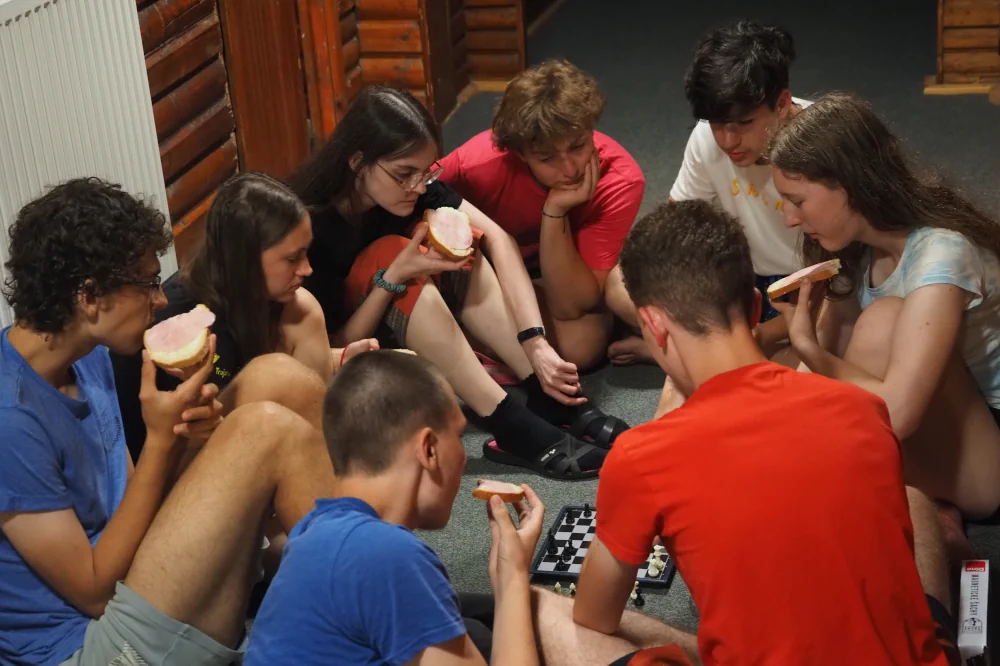 Účastníci sústredenia FKS hrajú šach a jedia desiatu